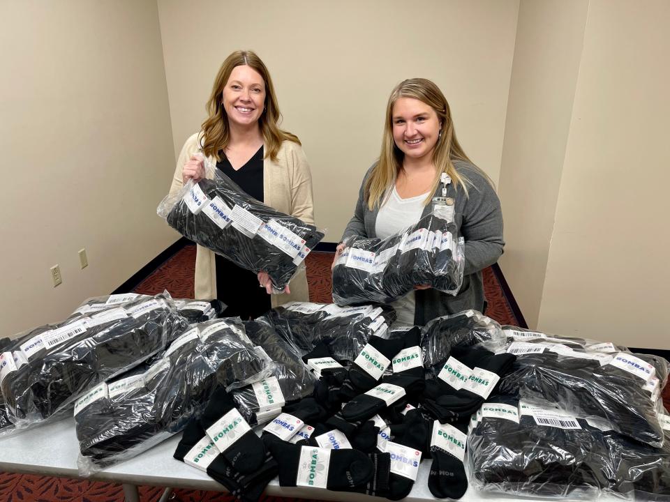 Shawn Fisher, left, Agnesian HealthCare Foundation executive director, and Megan Siedschlag, SSM Health Samaritan Clinic Affordable Care Act navigator, are shown with the 3,000 Bombas socks they will give to Samaritan Clinic patients, emergency room patients, and long-term facilities residents. For every Bombas item purchased, the company donates an item.