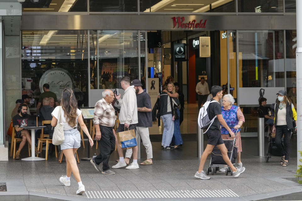 People walk outside the Westfield shopping mall at Bondi Junction in Sydney, Friday, April 19, 2024. The Sydney shopping mall reopened for business on Friday for the first time since it became the scene of a mass stabbing in which six people died on Saturday, April 13. (AP Photo/Mark Baker)