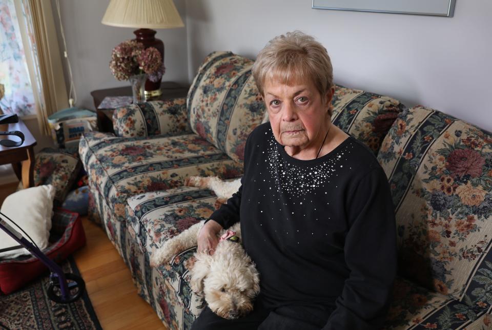 DeDe Cappellino Stapert sits in her Greece , NY home with her dog Lucy Thursday, April 28, 2022. Cappellino Stapert has lodged a complaint against a local Western New York nursing home for what she feels is a lack of care while she was there. 