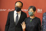 Hong Kong actress Paw Hee-ching, right, poses with her husband Fang Ping on the red carpet at the Hong Kong Film Awards, Sunday, July 17, 2022. (AP Photo/Kin Cheung)
