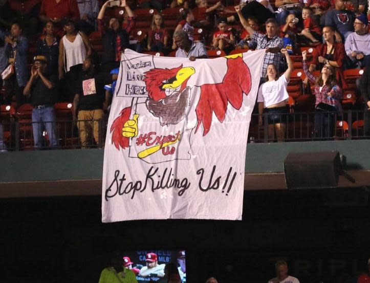 Protesters deliver message during Cardinals-Brewers game at Busch Stadium. (AP)