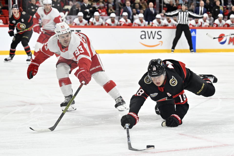 Detroit Red Wings Alex DeBrincat, left, and Ottawa Senators Tim Stützle during the NHL Global Series Sweden ice hockey match between Detroit Red Wings and Ottawa Senators at Avicii Arena in Stockholm, Sweden, Thursday, Nov. 16, 2023. (Henrik Montgomery/TT News Agency via AP)