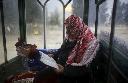 A security guard for the Waqf, the custodians of Muslim sites in Jerusalem, sits in a guard booth with foggy windows on the compound know to Muslims as al-Haram al-Sharif and to Jews as Temple Mount in Jerusalem's Old City in this January 7, 2013 file photo. REUTERS/Ammar Awad/Files