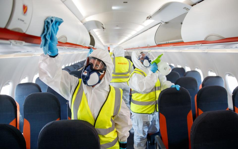 A handout photo issued by EasyJet of new bio security measures taking place on an EasyJet plane - EasyJet/Ben Queenborough