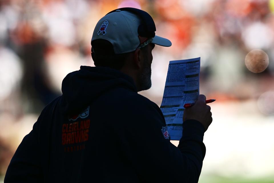 Cleveland Browns coach Kevin Stefanski looks at his playlist against the Pittsburgh Steelers on Nov. 19, 2023, in Cleveland.