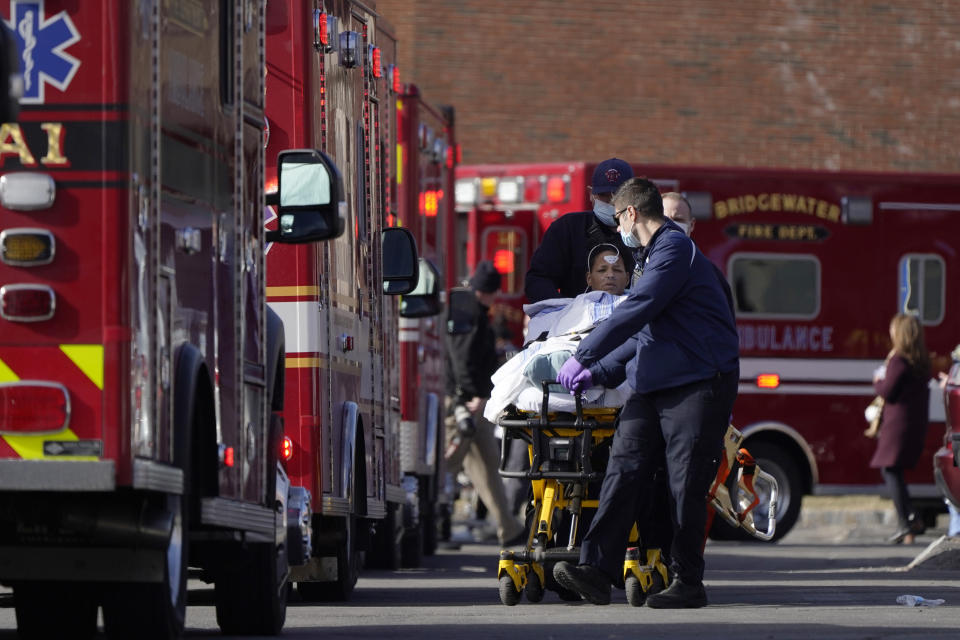 A patient, center, is placed into an ambulance while being evacuated from Signature Healthcare Brockton Hospital, Tuesday, Feb. 7, 2023, in Brockton, Mass. A fire at the hospital's electrical transformer forced an undetermined number of evacuations Tuesday morning and power was shut off to the building for safety reasons, officials said. (AP Photo/Steven Senne)