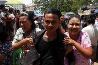 A released prisoner reacts with his relatives outside the Insein prison in Yangon