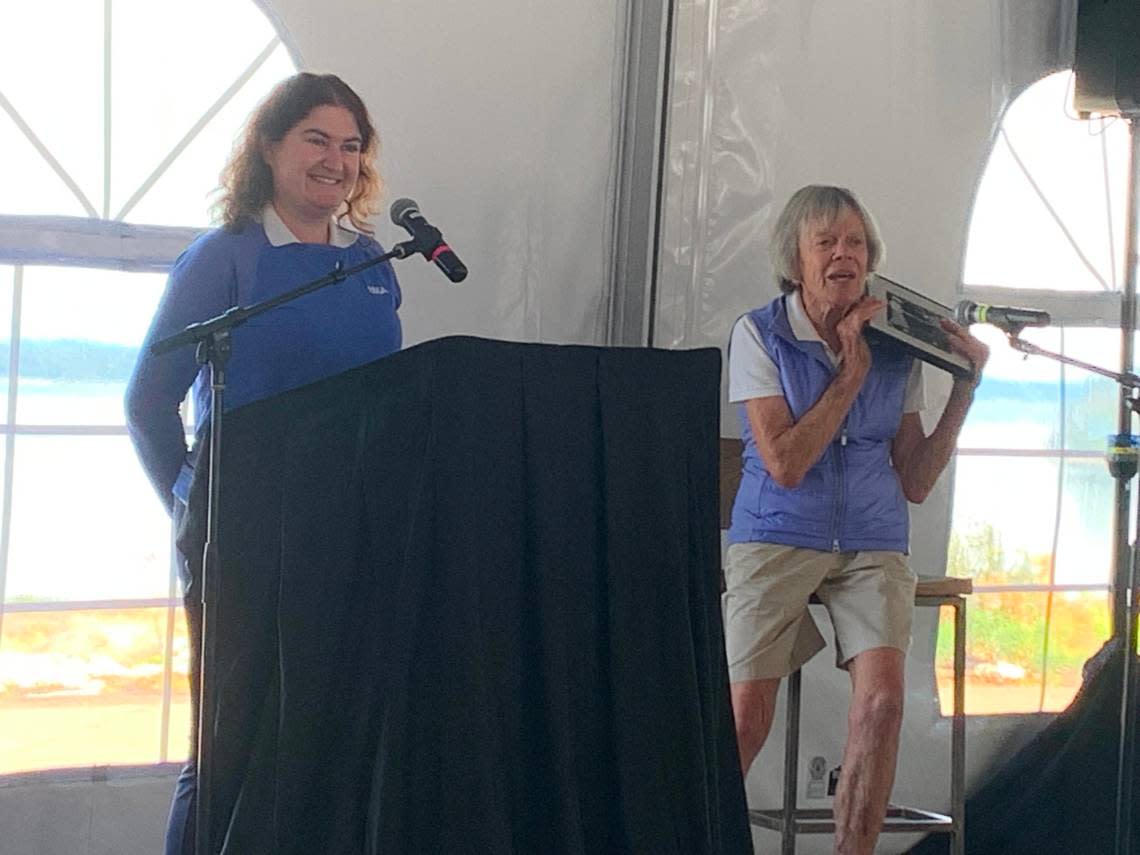 Ann Sander (right), seven-time United States Golf Association champion from Marysville, displays a picture of her and rival JoAnne Carner from Seattle competing in the 1950s. Sander and Julia Pine (left), director of championship communications for the USGA, helped welcome the 122nd U.S. Women’s Amateur Championship to Chambers Bay Golf Course Aug. 8-14 during a kickoff event at the Pierce County-owned course Thursday, July 7, 2022.