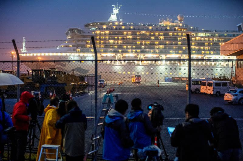 FILE PHOTO : A bus arrives near the cruise ship Diamond Princess, where dozens of passengers were tested positive for coronavirus, at Daikoku Pier Cruise Terminal in Yokohama