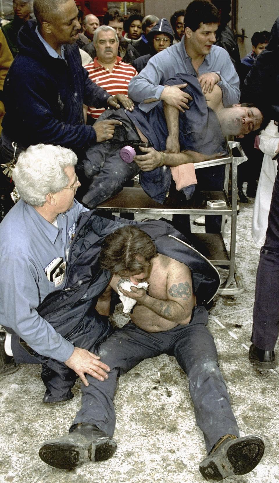 FILE - Victims of a fire at the World Trade Center in New York are treated at the scene, Feb. 26, 1993. New York City is marking the anniversary of the 1993 bombing that blew apart a van parked in an underground garage, killing six people and injured more than 1,000. The Port Authority of New York and New Jersey is holding a memorial Mass on Monday, Feb. 26, 2024 at St. Peter’s Church in Manhattan. (AP Photo/Marty Lederhandler, file)