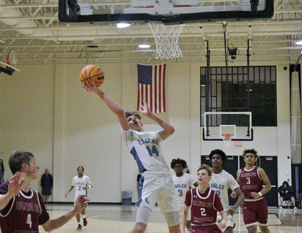 St. John Paull II's Rowan Linder drives to the paint and goes up for a layup during the fourth quarter of the Eagles' regional semifinals win on Feb. 22, 2022. He scored five points, all in the fourth quarter, to help the Eagles pull away.