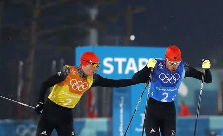 Nordic Combined Events - Pyeongchang 2018 Winter Olympics - Men's Team 4 x 5 km Final - Alpensia Cross-Country Skiing Centre - Pyeongchang, South Korea - February 22, 2018 - Eric Frenzel of Germany and Johannes Rydzek of Germany exchange. REUTERS/Kai Pfaffenbach