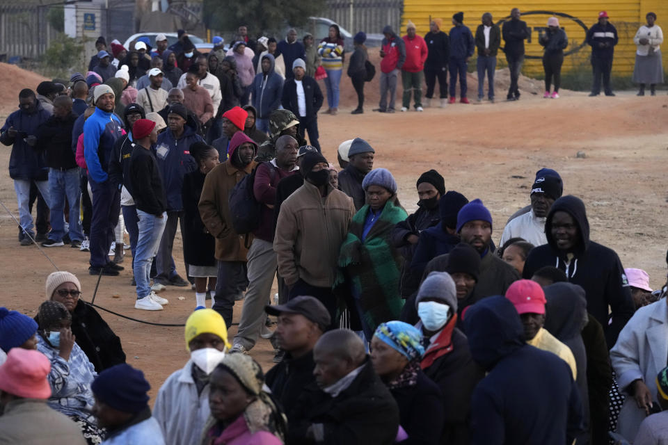 FILE - Voters queue to cast their ballots for general elections in Alexandra, near Johannesburg, South Africa, on May 29, 2024. South Africa is in a moment of deep soul-searching after an election that brought a jarring split from the African National Congress, the very party that gave the country freedom and democracy 30 years ago.(AP Photo/Themba Hadebe, File)