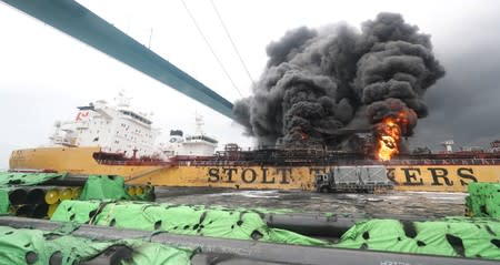 Smoke rises from a fire at a vessel at a port in Ulsan