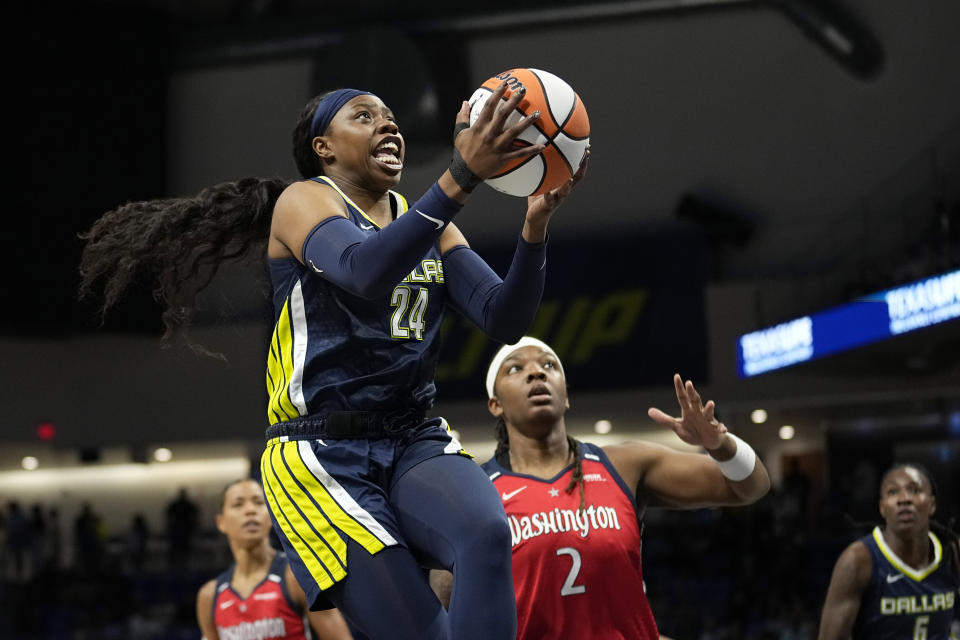 Dallas Wings guard Arike Ogunbowale (24) goes to the basket next to Washington Mystics forward Myisha Hines-Allen (2) during the first half of a WNBA basketball game Friday, July 28, 2023, in Arlington, Texas. (AP Photo/Tony Gutierrez)