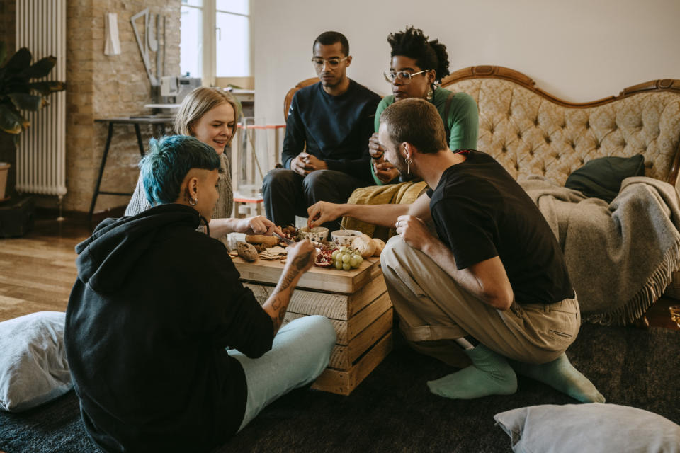 A group of friends sitting around eating together