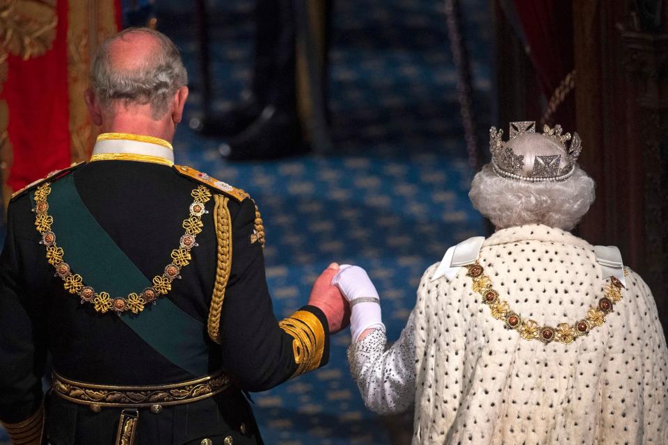 Britain's Queen Elizabeth II, right, leaves with Britain's Prince Charles after delivering the queen's speech at the state opening of Parliament in the Houses of Parliament in London on Oct. 14, 2019.