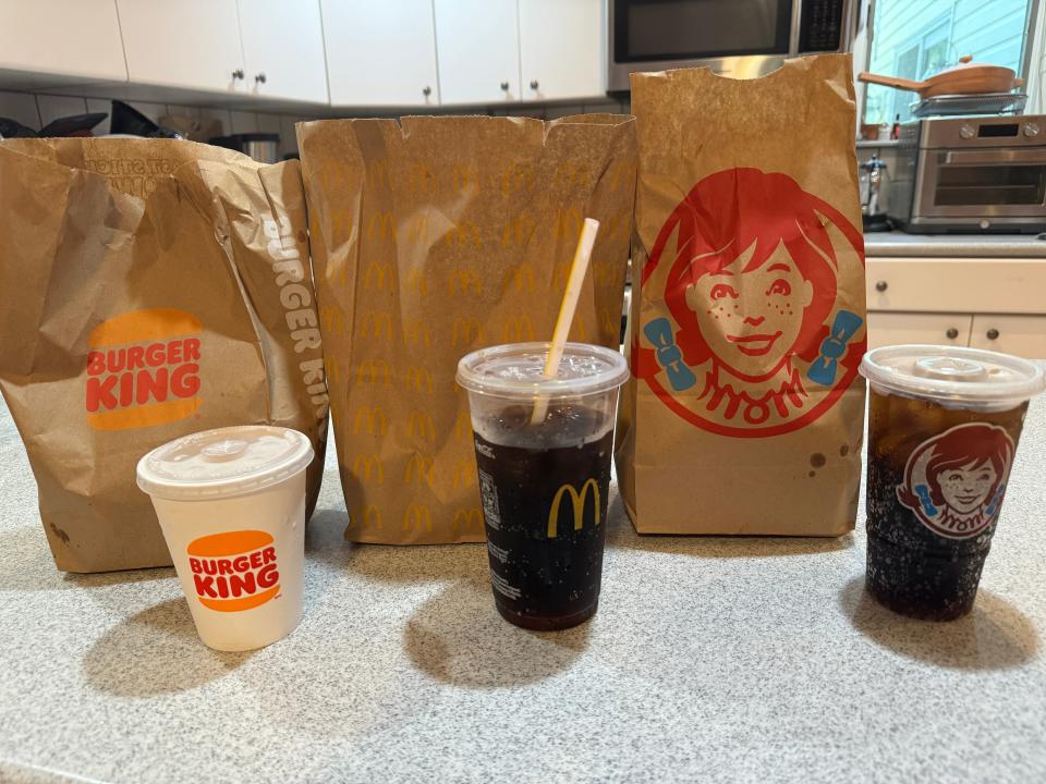 from left to right: the burger king meal, the mcdonald's meal, and the Wendy's meal with drinks