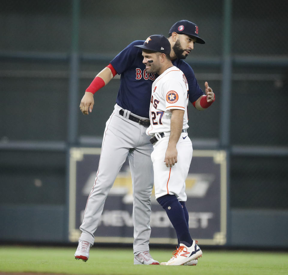 Boston Red Sox's Marwin Gonzalez hugs Houston Astros' Jose Altuve (27) before a baseball game Monday, May 31, 2021, in Houston. (Karen Warren/Houston Chronicle via AP)