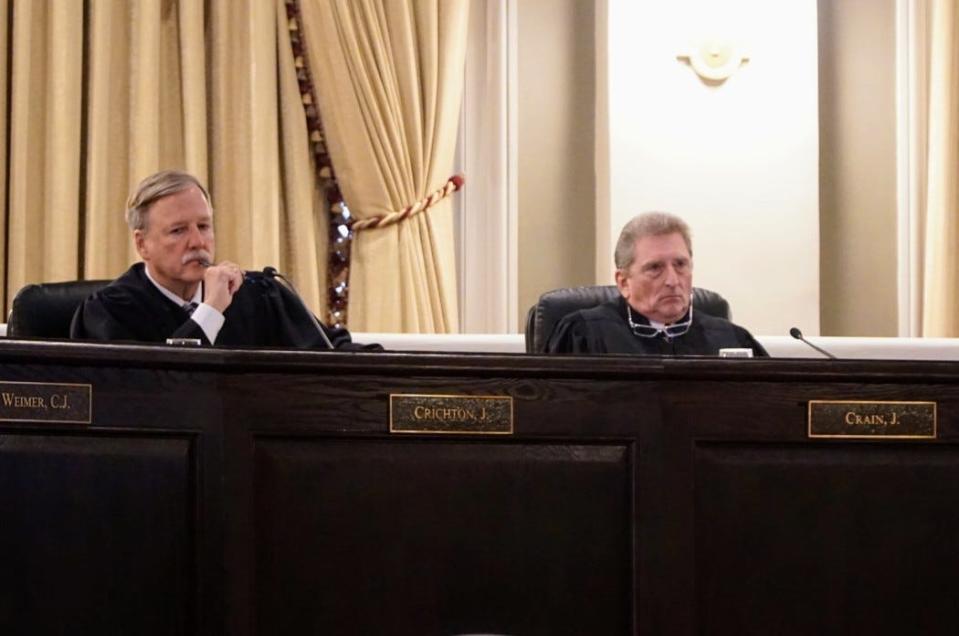 Associate Justices Scott Crichton, left, and Will Crain listen to arguments during a hearing of the Louisiana Supreme Court on Tuesday, Dec. 7, 2021.