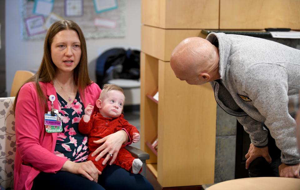 Dr. Roger Vazquez, director of the Akron Childrens Hospital neonatal intensive care unit at Aultman Hospital in Canton, popped in to see former patient Ella Hake. She spent 117 days inside the hospital. Dr. Arielle Bokisa, another neonatal physician, is holding Ella.