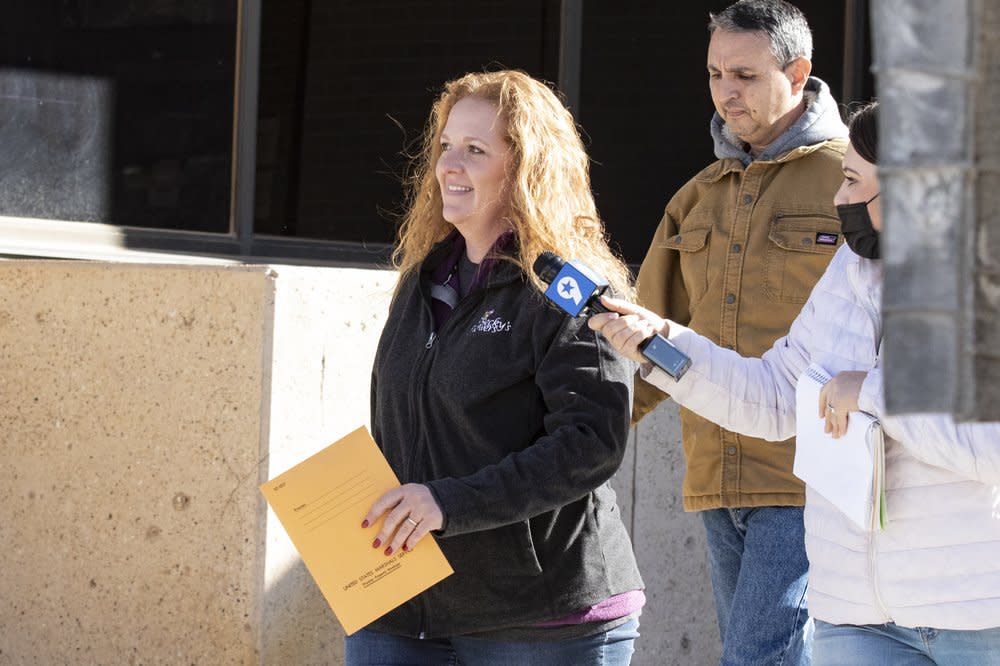 In this Jan. 13, 2021 file photo, Jenny Cudd, a flower shop owner and former Midland mayoral candidate, and Eliel Rosa leave the federal courthouse in Midland, Texas. (Jacob Ford/Odessa American via AP, File)