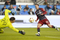 Sporting Kansas City goalkeeper Tim Melia (29) makes a save as Toronto FC forward Federico Bernardeschi (10) looks on during the first half of an MLS soccer game in Toronto, Ontario, Saturday, March 30, 2024. (Frank Gunn/The Canadian Press via AP)