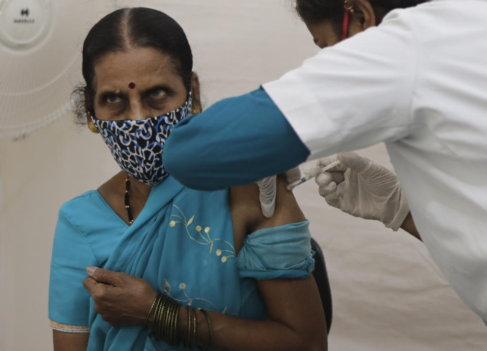 A health worker administers a dose of vaccine for COVID-19 to a woman at vaccination centre in Mumbai, India, Thursday, May 27, 2021. (AP Photo/Rajanish Kakade)