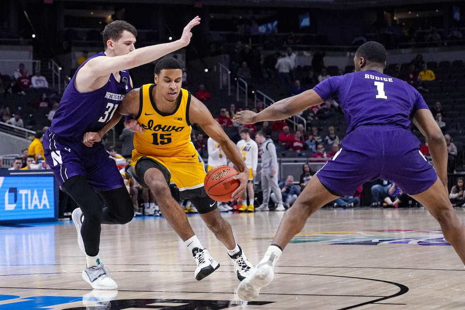 Iowa forward Keegan Murray (15) drives on Northwestern forward Robbie Beran (31) in the first half of an NCAA college basketball game at the Big Ten Conference tournament in Indianapolis, Thursday, March 10, 2022. (AP Photo/Michael Conroy)