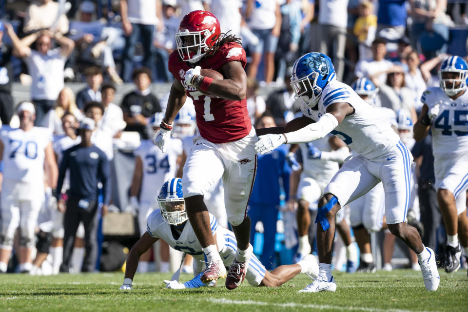 Oct 15, 2022; Provo, Utah, USA; Arkansas Razorbacks tight end Trey Knox (7) runs just out of reach of Brigham Young University cornerback Mandell D’Angelo (5) in the first half as the Razorbacks face the Cougars at LaVell Edwards Stadium. Mandatory Credit: Gabriel Mayberry-USA TODAY Sports