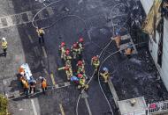 Firefighters carry a body at the site of a fire at a lithium battery manufacturing factory in Hwaseong, South Korea, Monday, June 24, 2024. (Newsis via AP)