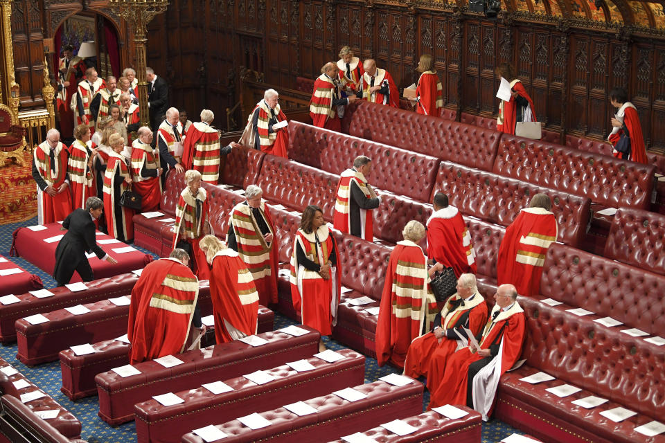 Members of the House of Lords arrive to sit in their seats ahead of the official State Opening of Parliament in London, Monday Oct. 14, 2019. (Toby Melville/Pool via AP)