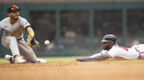 Pittsburgh Pirates second baseman Tucupita Marcano, left, waits for the ball to tag out Atlanta Braves' Michael Harris II, right, in the fifth inning of a baseball game Saturday, June 11, 2022, in Atlanta. (AP Photo/Hakim Wright Sr.)