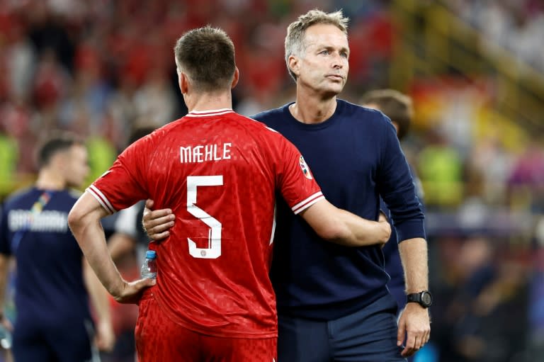 Denmark coach Kasper Hjulmand with <a class="link " href="https://sports.yahoo.com/soccer/players/821639/" data-i13n="sec:content-canvas;subsec:anchor_text;elm:context_link" data-ylk="slk:Joakim Maehle;sec:content-canvas;subsec:anchor_text;elm:context_link;itc:0">Joakim Maehle</a> after the 2-0 loss to Germany which saw them go out of Euro 2024 (KENZO TRIBOUILLARD)