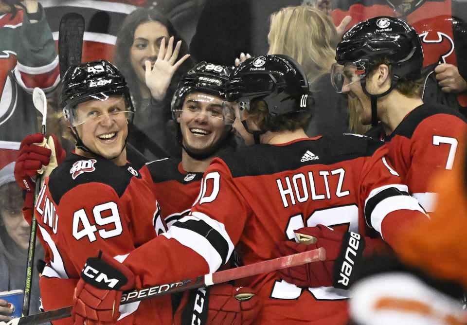 New Jersey Devils center Jack Hughes (86) celebrates his goal with teammates during the first period of an NHL hockey game against the Philadelphia Flyers Thursday, Dec. 15, 2022, in Newark, N.J. (AP Photo/Bill Kostroun)