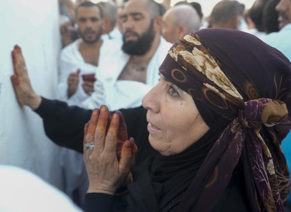 A Muslim pilgrim prays on the rocky hill known as the Mountain of Mercy, on the Plain of Arafat, during the annual hajj pilgrimage, near the holy city of Mecca, Saudi Arabia, Friday, July 8, 2022. One million pilgrims from across the globe amassed on Thursday in the holy city of Mecca in Saudi Arabia to perform the initial rites of the hajj, marking the largest Islamic pilgrimage since the coronavirus pandemic upended the annual event, a key pillar of Islam. (AP Photo/Amr Nabil)