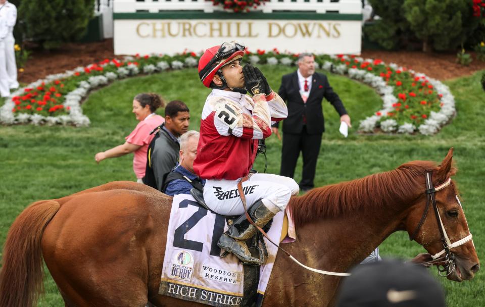 Jockey Sonny Leon clasps his hands and looks skyward after Rich Strike won the 148th Kentucky Derby.