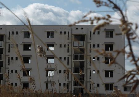 A tsunami-devastated apartment building is seen at the coastal area in Rikuzentakata, Iwate prefecture, Japan, March 2, 2016, ahead of the five-year anniversary of the March 11, 2011 earthquake and tsunami disaster. REUTERS/Elaine Lies