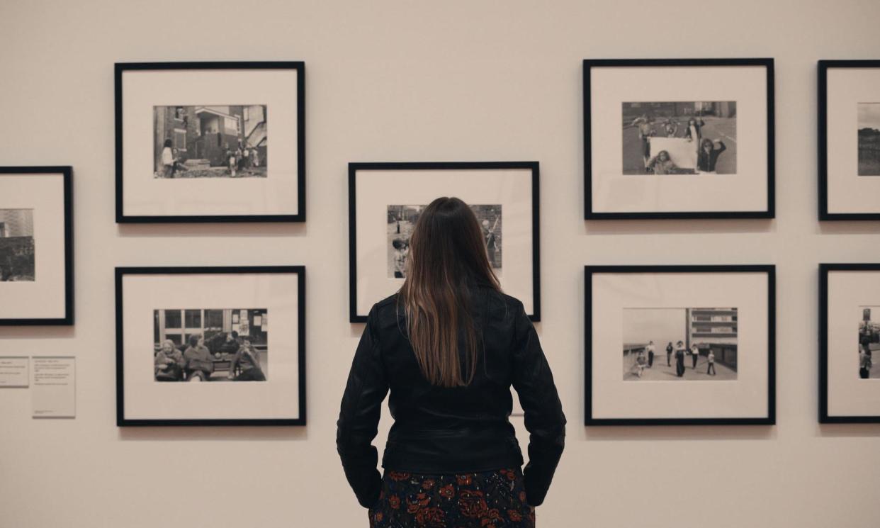 <span>Ella Murtha looks at her mother’s work on display at Tate Britain. Tish Murtha created portraits of working-class life in Newcastle’s west end in the 1970s and 80s.</span><span>Photograph: Screengrab/BBC/Freya Films/Demon Snapper Productions</span>