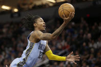 Memphis Grizzlies guard Ja Morant grabs the ball against the Minnesota Timberwolves in the second quarter of an NBA basketball game Wednesday, Nov. 30, 2022, in Minneapolis. (AP Photo/Andy Clayton-King)