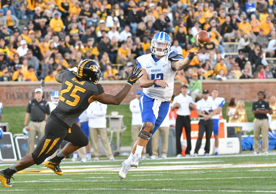 Middle Tennessee quarterback Brent Stockstill (12) throws a pass as Missouri linebacker Donavin Newsom pressures him during the second half of their 2016 game at Faurot Field.