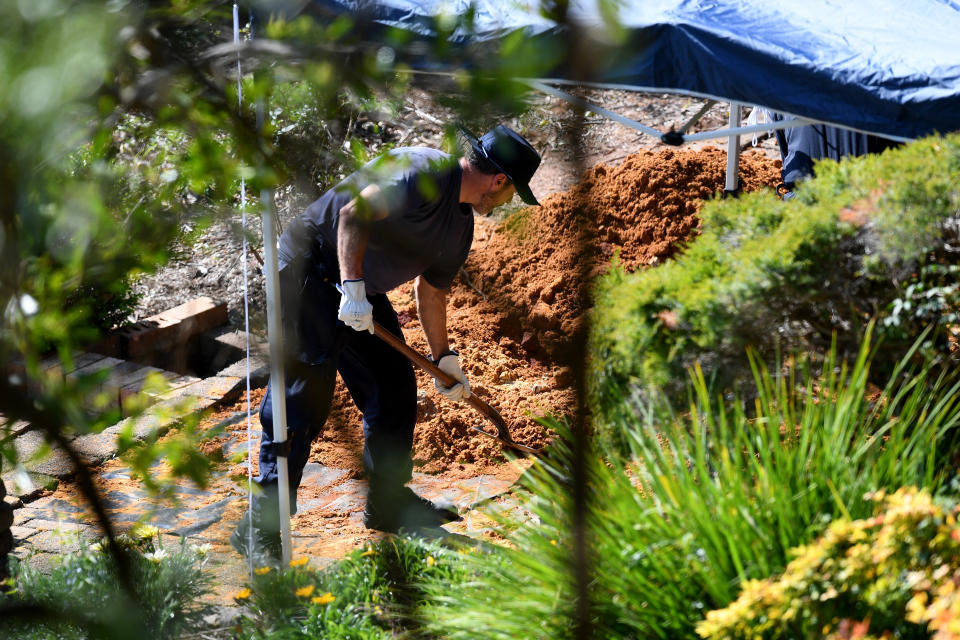<span>NSW Police and Forensic Services personnel are seen sifting through dirt as Ms Dawson’s home in September this year. Image: AAP</span>
