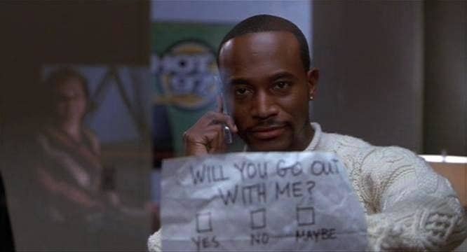 Taye Diggs in "Brown Sugar" holding up a sign that says, will you go out with me