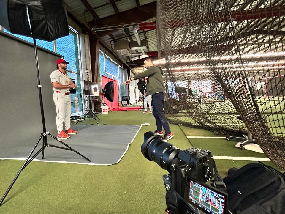 Enquirer photographer Kareem Elgazzar prepares to capture an image of Reds non-roster catcher Michael Trautwein at spring training in Goodyear, Arizona.