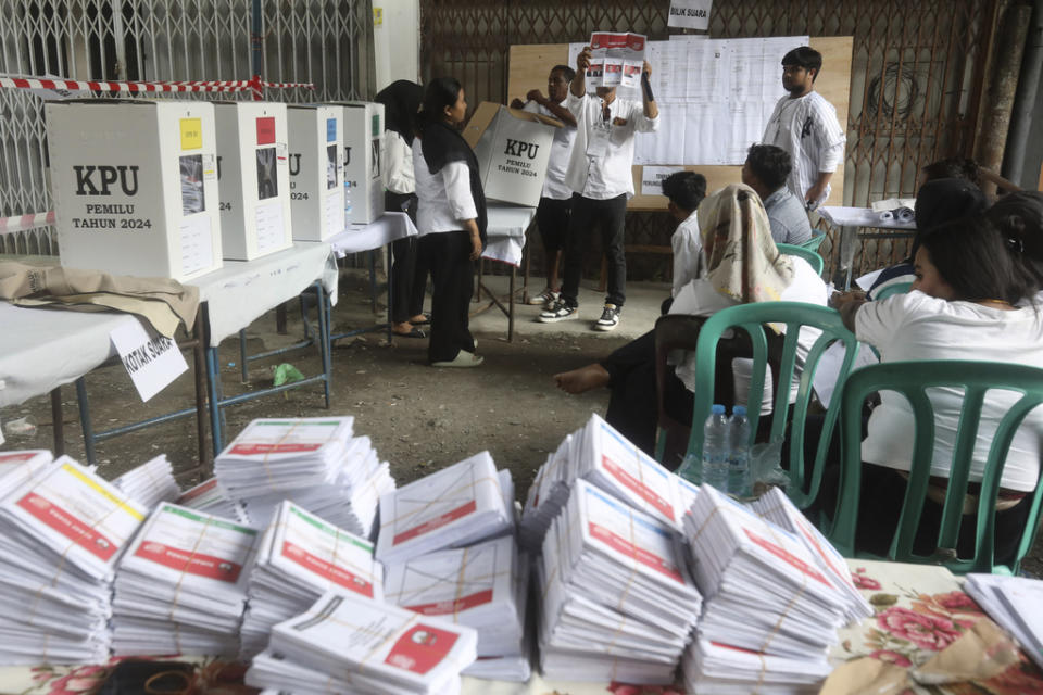 An electoral worker holds up a ballot during the vote counting at a polling station following the election in Medan, Indonesia, Wednesday, Feb. 14, 2024.<span class="copyright">Binsar Bakkara—AP</span>