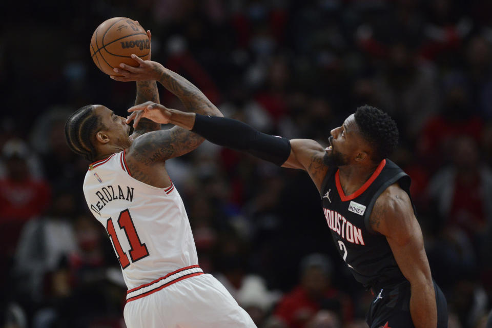 Chicago Bulls forward DeMar DeRozan (11) goes up to shoot against Houston Rockets forward David Nwaba (2) during the first half of an NBA basketball game Monday, Dec. 20, 2021, in Chicago. (AP Photo/Paul Beaty)