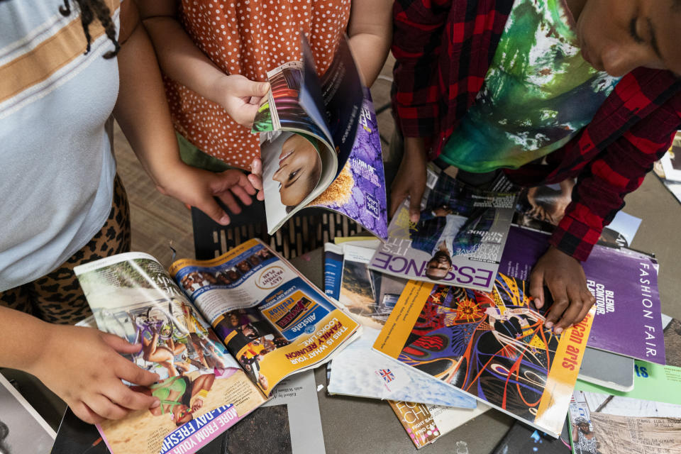 Campers look through magazines including Essence as they make a collage art project while attending Camp Be’chol Lashon, a sleepaway camp for Jewish children of color, Thursday, July 27, 2023, in Petaluma, Calif., at Walker Creek Ranch. Art projects encompass aspects of world cultures and incorporate Jewish elements. (AP Photo/Jacquelyn Martin)