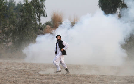 A supporter of Pakistani opposition leader Imran Khan runs during clashes between police and protesters in Swabi, between Peshawar and Islamabad, Pakistan October 31, 2016. REUTERS/Fayaz Aziz