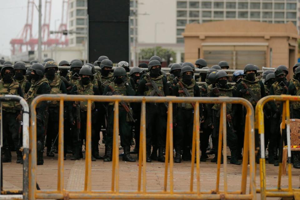 Sri Lankan soldiers block and guard the access road of the president’s secretariat (EPA)