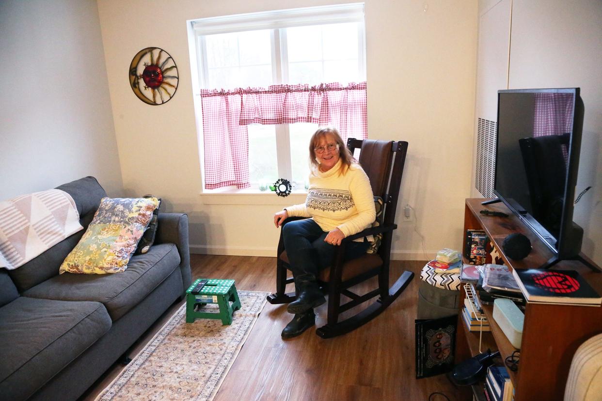 Champlin Place resident Kathy Giberson enjoys her living room at the new Easterseals' over-62 affordable living complex in Rochester.